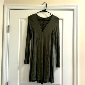 Long sleeve t shirt dress with criss cross detailing on the front.